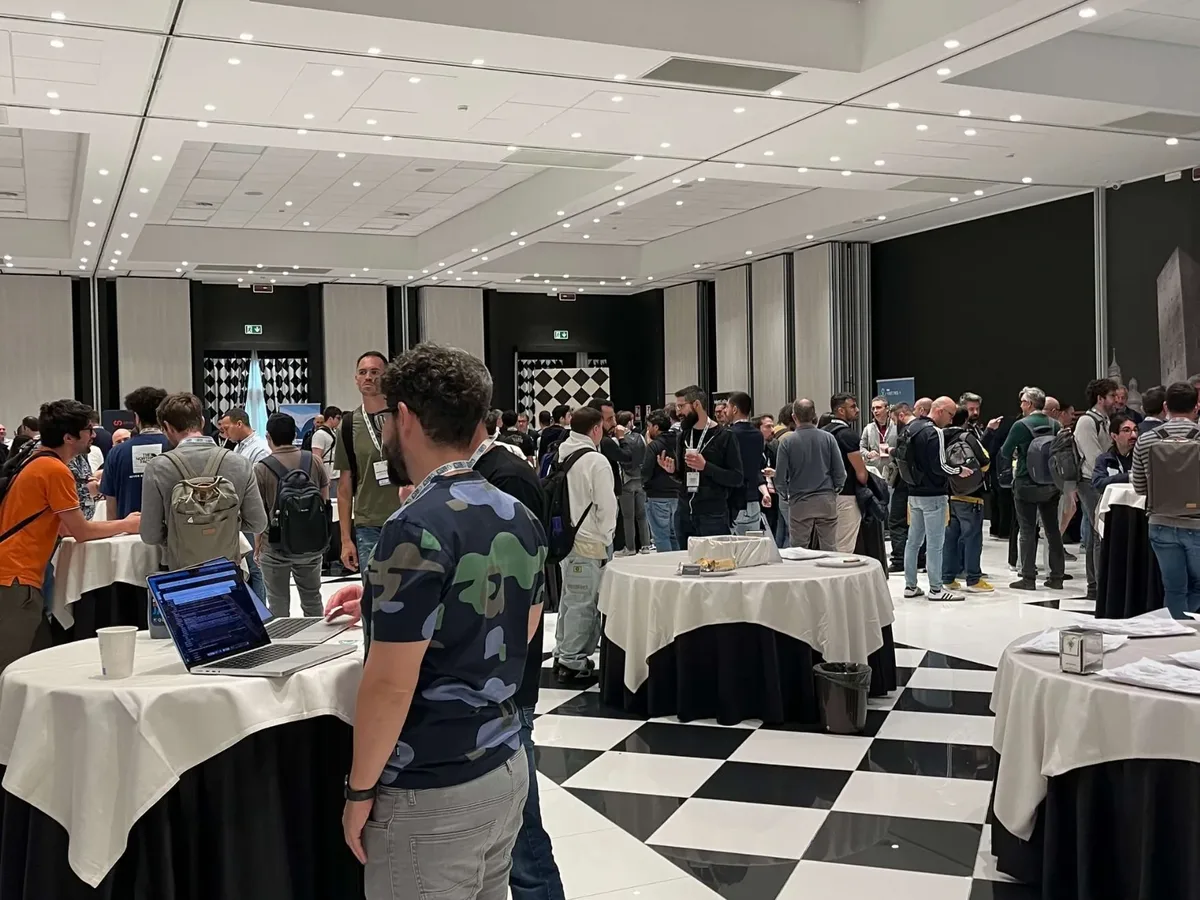 A break between talks, standing tables and open laptops