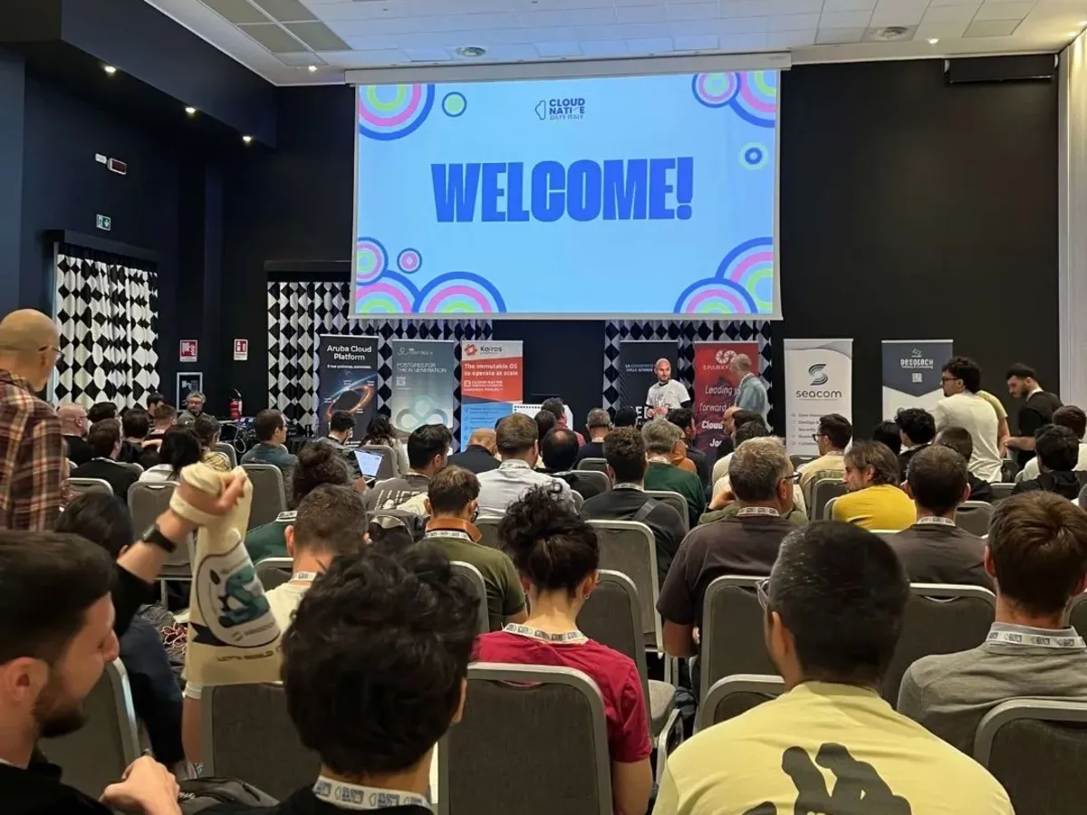 The main room filling up in front of the Welcome slide
